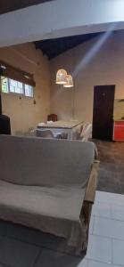 a room with tables and chairs and a chandelier at Chalet La Gran Familia in San Bernardo