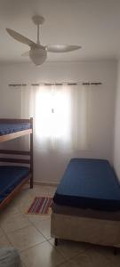 En eller flere senge i et værelse på Nostra casa Peruibe