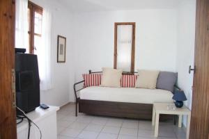 a living room with a couch and a tv at Maria's house 2 in Edipsos