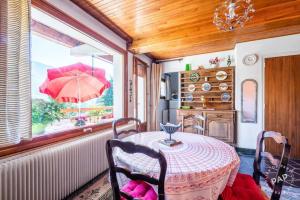 a dining room with a table and a window with an umbrella at Apt Morzine 1000 in Morzine