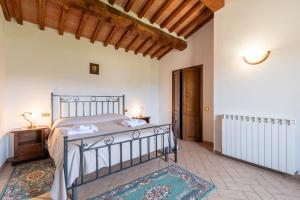 a bedroom with a bed and a wooden ceiling at Pugnano Alto- appartamento Girasole in Lisciano Niccone +27 photos