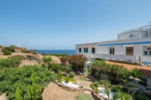 an aerial view of a house with the ocean in the background at Casa Nora in Calasetta