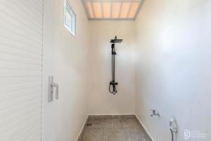 a bathroom with a cross on the wall at Fortune Glamping in Dieng