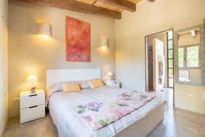 a bedroom with a large bed and a mirror at Casa Cascada in Costitx +32 photos