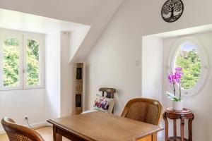 a dining room with a wooden table and chairs at Chambre d'hôtes Kerdary in Nivillac +16 photos