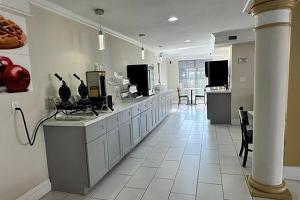 a large kitchen with a counter and a room at Super 8 by Wyndham Nacogdoches Near University in Nacogdoches +5 photos
