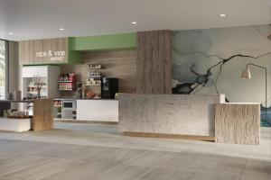 a living room with a counter and a kitchen at Wyndham Garden Anna in Anna