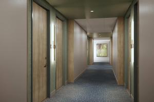 a long corridor with wooden doors and a hallway with a corridorngthngthngthngth at Wyndham Garden Anna in Anna