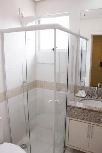 a bathroom with a shower and a sink at Hotel Porto Madero in Florianópolis