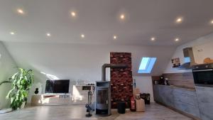 a kitchen with a brick fireplace in the middle at Ferienglück Goldach in Hallbergmoos