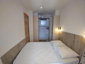 Un ou plusieurs lits dans un hébergement de l'établissement Appartement à 100m de la plage