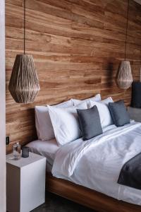 a bedroom with a bed with a wooden wall at Batur Cabins in Kintamani +69 photos