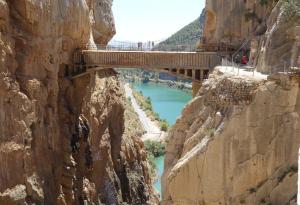 a bridge on the side of a cliff over a river at Apartamento Valle de Abdalajis in Málaga