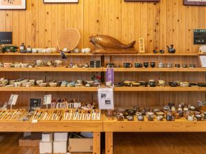 a store with wooden shelves filled with lots of books at Tabist Fontana no Oka Kamou in Aira