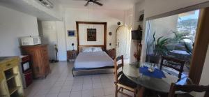 a bedroom with a bed and a table in a room at Casa Pura Vida in Cabo San Lucas +13 photos