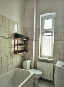 a bathroom with a tub and a toilet and a sink at Haus Sonnenschein in Reuterstadt Stavenhagen