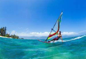 a man riding a wind sail on the ocean at Royal Kahana 909 · RK 909 OceanFront Condo w Beautiful Ocean Vie in Kahana