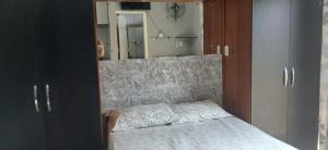 a bedroom with a bed with a mirror in it at Vera's Apart-Hotel & Restaurante in Belém