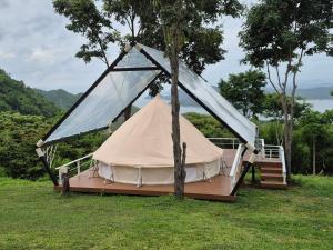 a tent in a field with a tree at The Hilltop Erawan in Si Sawat +24 photos
