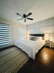 a bedroom with a bed with a ceiling fan at Pickleball , Pool , Bkyd Oasis , Centrally Located in Frisco +39 photos