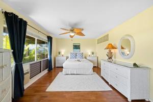 a bedroom with a bed and a ceiling fan at Kaanapali Plantation 10 · KPL 10 Panoramic Ocean Views 2BD near in Lahaina +42 photos