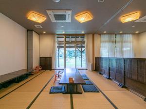 a conference room with a table and chairs in it at Tabist Fontana no Oka Kamou in Aira