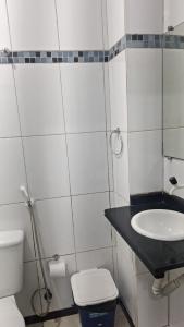 a small bathroom with a sink and a toilet at Vera's Apart-Hotel & Restaurante in Belém +42 photos