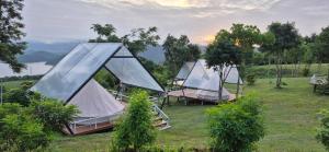 a group of tents sitting on a field at The Hilltop Erawan in Si Sawat