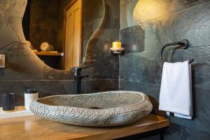 a bathroom with a large tire sink on a counter at Lodge para parejas con jacuzzi hidromasaje in Panguipulli +20 photos