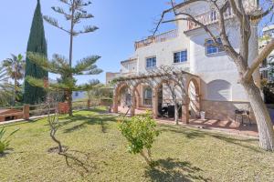 un gran edificio blanco con un árbol en el patio en Casa Alba, en Salobreña