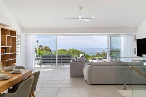 a living room with a couch and a table at Thalassa Views Ulladulla in Ulladulla