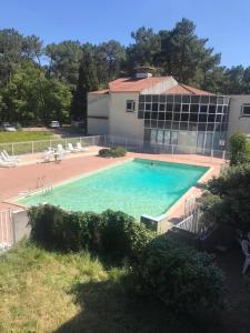 a large swimming pool in front of a building at Appartement au Parc de la Grange in Jard-sur-Mer