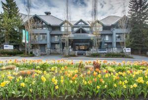 un gran edificio con flores delante en Glacier Lodge 216 by Outpost Whistler, en Whistler
