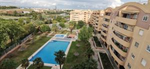 an apartment with a swimming pool in a building at Bonitas Vistas a Sevilla in San Juan de Aznalfarache