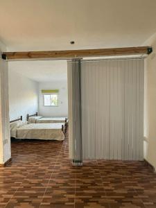 a bedroom with a bed and a large sliding door at Depto Santa Cruz in Villa Santa Cruz del Lago +19 photos