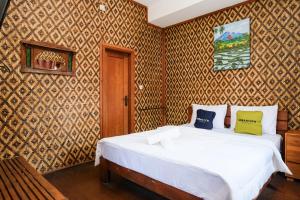 Ένα ή περισσότερα κρεβάτια σε δωμάτιο στο Urbanview Hotel Tan Jokteng Prawirotaman