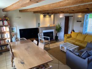 a living room with a couch and a table at L'hébergerie sablotine in Chaillé-les-Marais