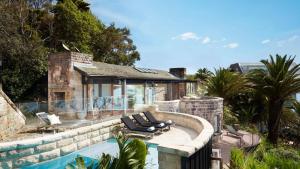 a house with a swimming pool next to a house at Northview Villa in Palm Beach