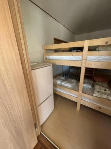 a room with two bunk beds in a room at Southern Gate HIVE in Ishigaki Island