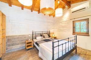 a bedroom with a bed and a wooden ceiling at Mini Country House in Sidari