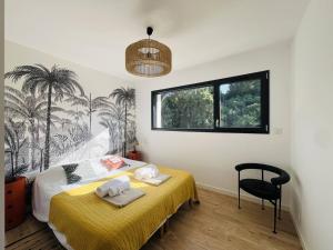 a bedroom with a yellow bed and a black chair at Villa 8 pers à Seignosse avec piscine chauffée et clim - FR-1-791-44 in Seignosse