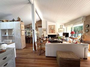 a living room with a couch and a table at Charmante villa familiale au Cap Ferret, proche plages, 9 pers - FR-1-736-68 in Cap-Ferret