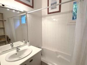 a white bathroom with a sink and a bath tub at Charmante villa familiale au Cap Ferret, proche plages, 9 pers - FR-1-736-68 in Cap-Ferret +12 photos