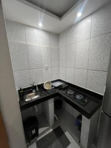 a small bathroom with a sink and a counter at Casa completa no centro de Belém in Belém
