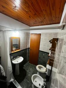 a bathroom with two toilets and a sink at Tu lugar en Santa Clara in Santa Clara del Mar