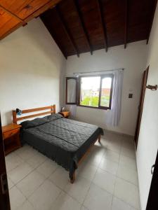a bedroom with a bed and a window at Tu lugar en Santa Clara in Santa Clara del Mar