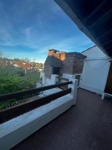 a balcony of a house with a brick fireplace at Tu lugar en Santa Clara in Santa Clara del Mar