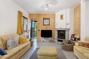 a living room with a couch and a fireplace at Case Vacanza Newmood - Intera Villa in Aymavilles