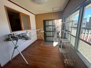 a room with a balcony with a view of a city at Southern Gate HIVE in Ishigaki Island
