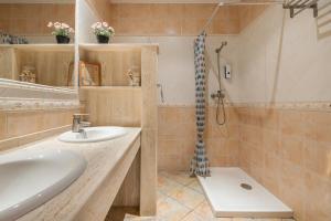 a bathroom with a sink and a shower at Can León in Almodóvar del Río +19 photos